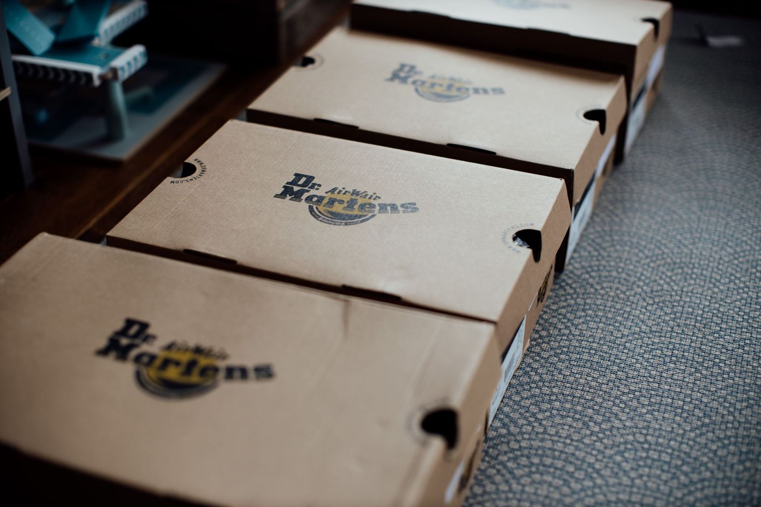 Row of wooden boxes with vintage-style branding and logos.