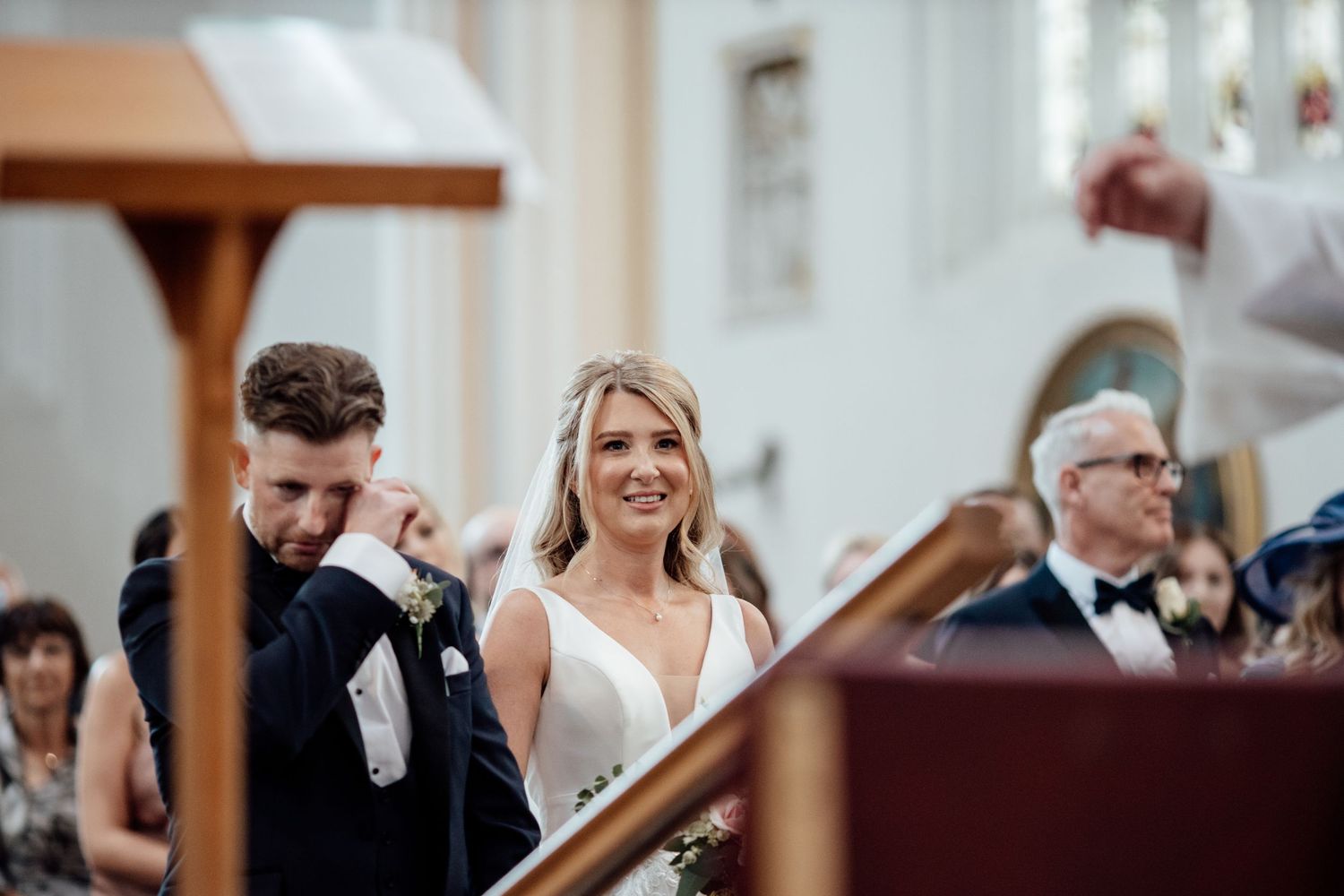 Wedding celebration candid moments captured during indoor reception with natural lighting.