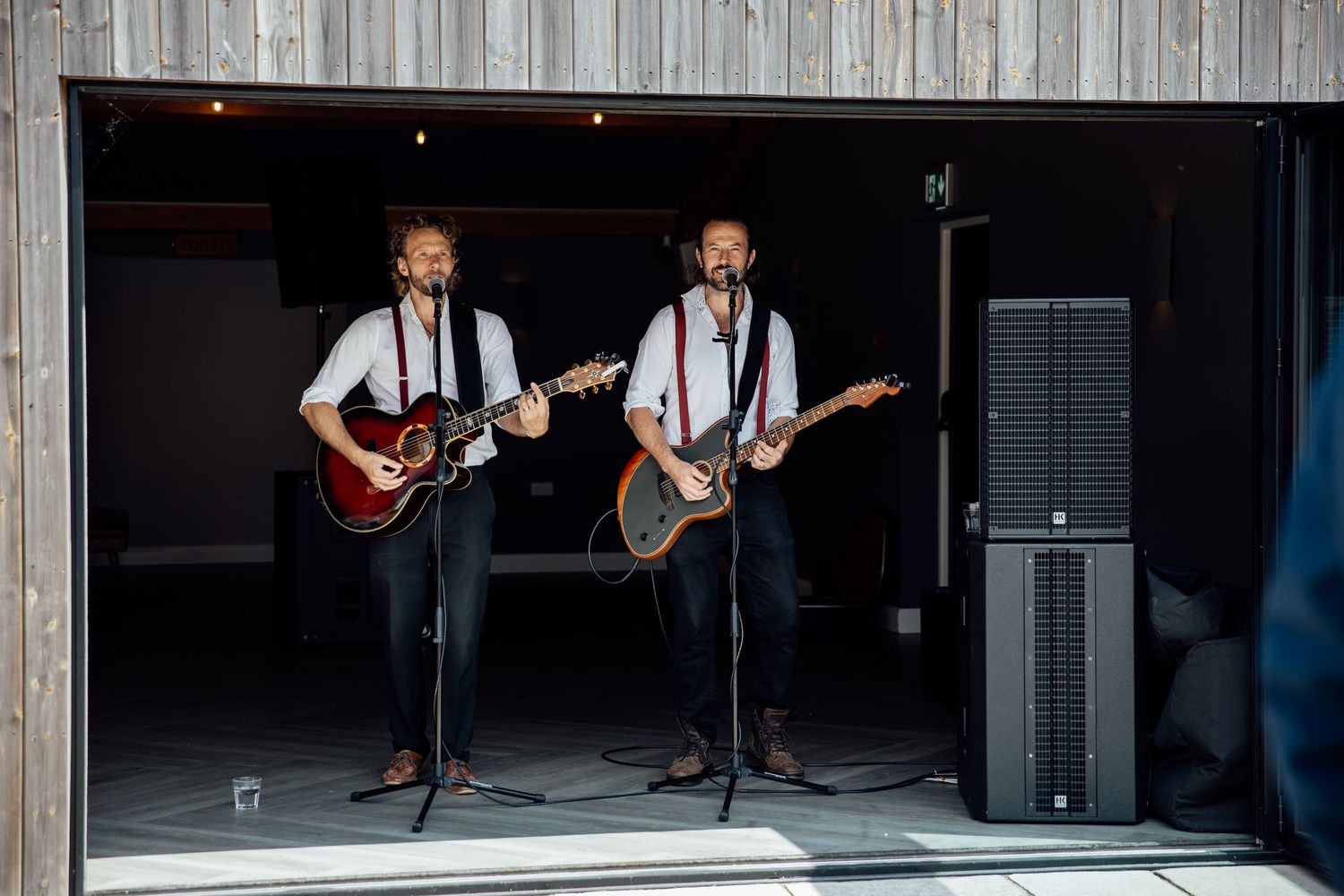 Live band performing at rustic barn wedding reception venue.