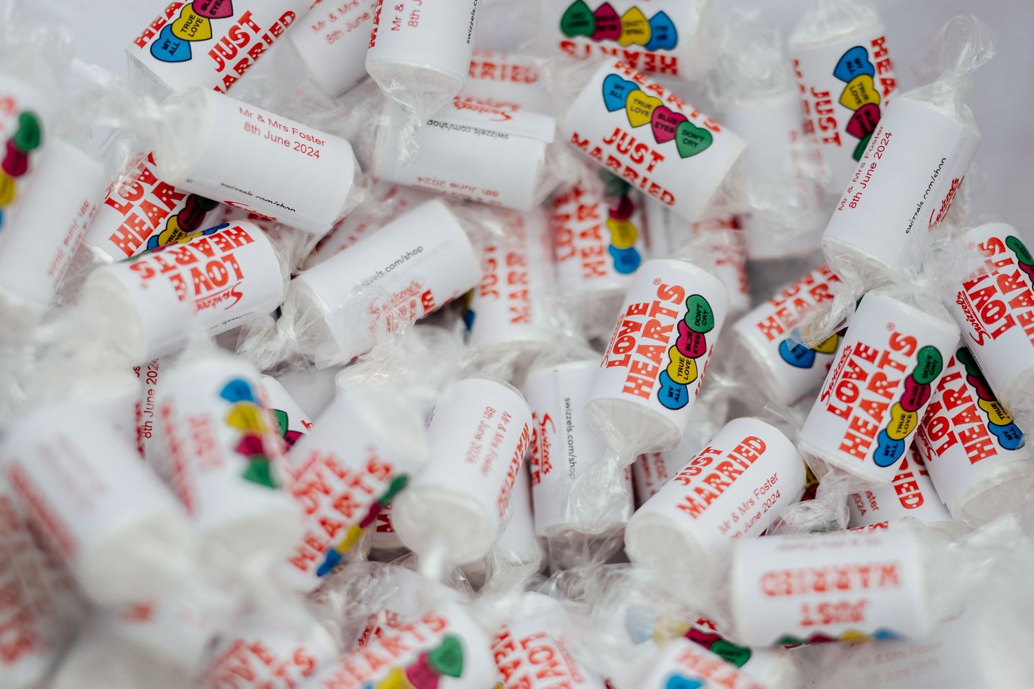 Close-up view of colorful candy favors in clear wrappers arranged in a pattern.
