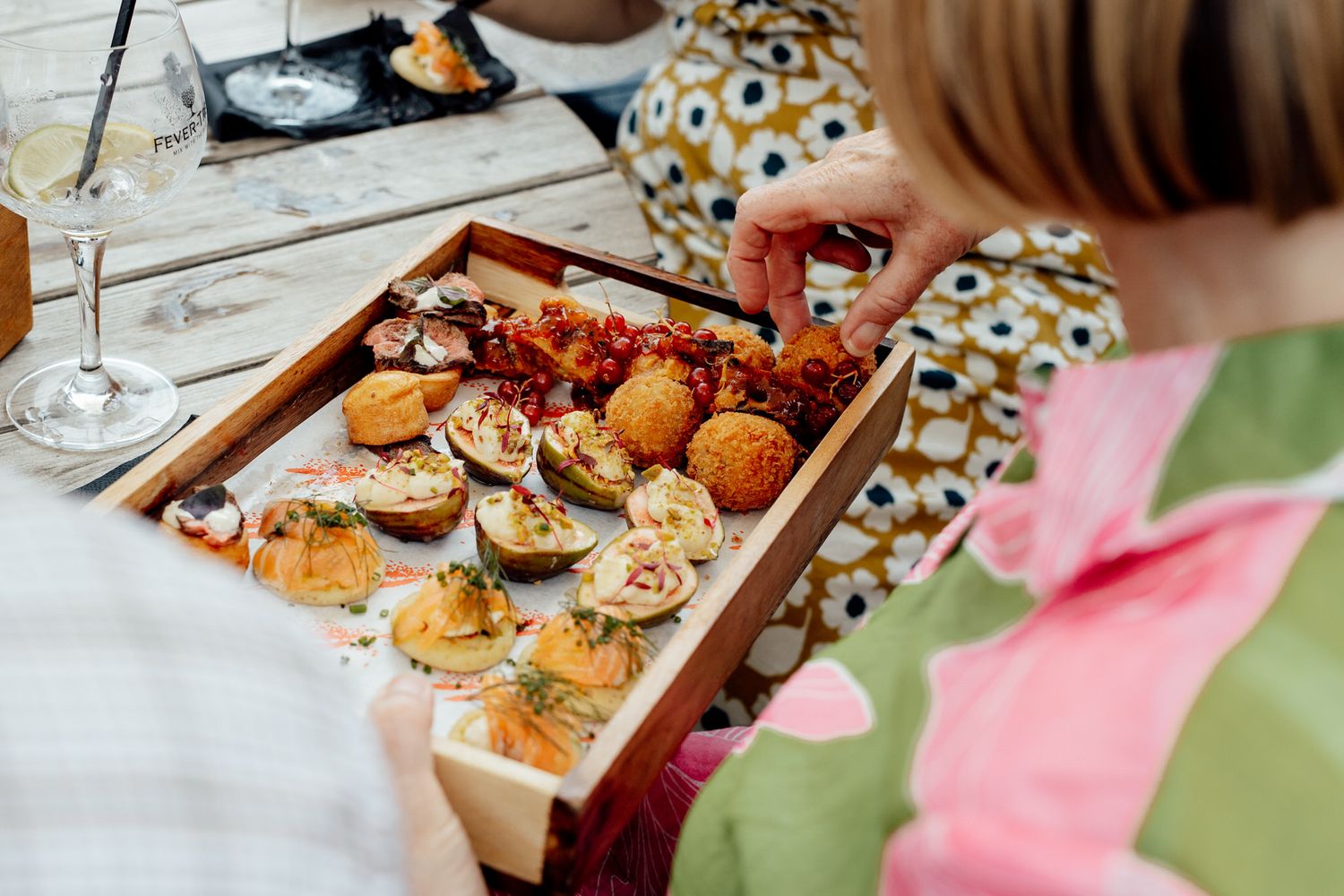 Wedding reception appetizers and hors d'oeuvres displayed on a decorated table.