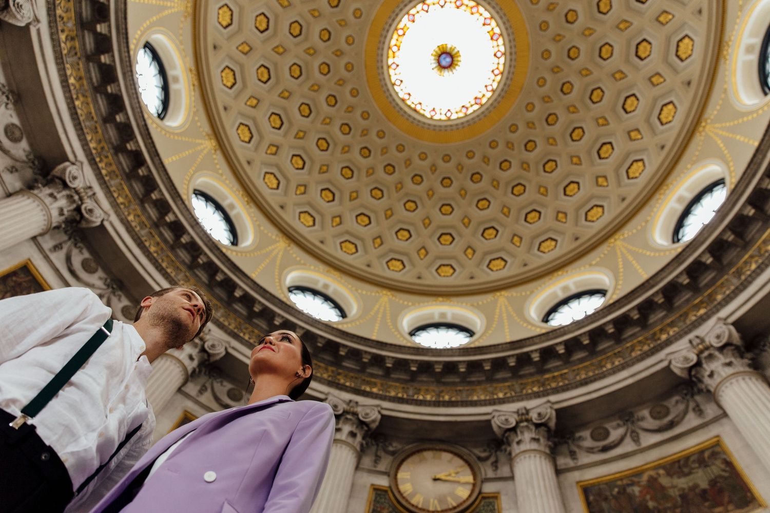 Ornate domed ceiling with circular patterns and decorative moldings in a historic building.