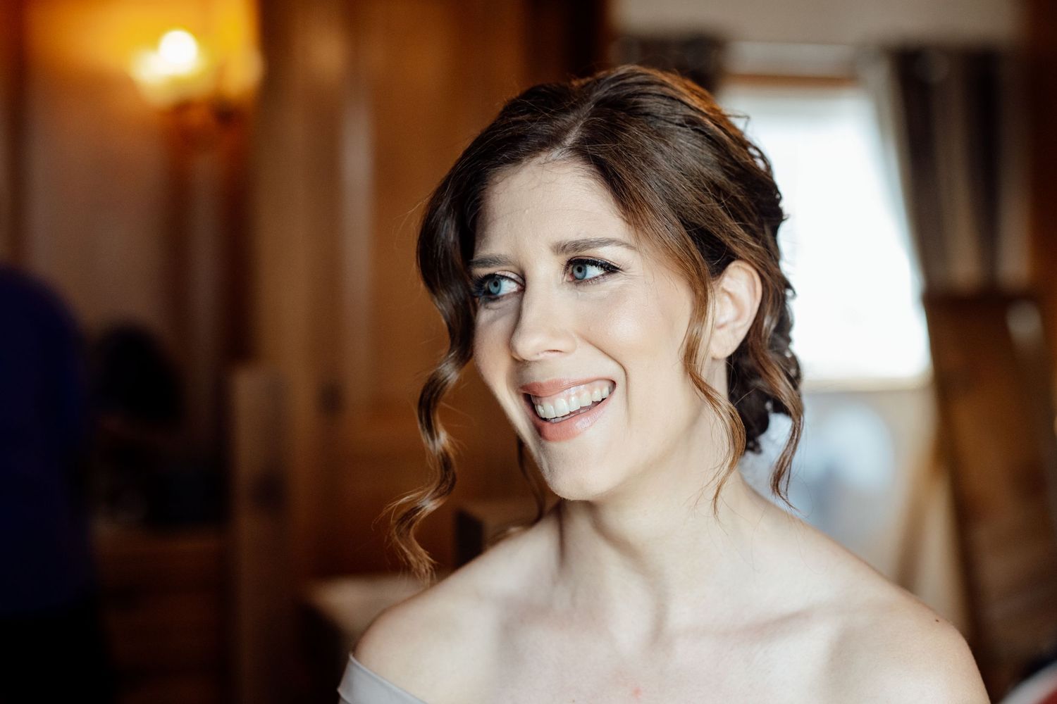 Soft window light illuminates an elegant bridal preparation scene.