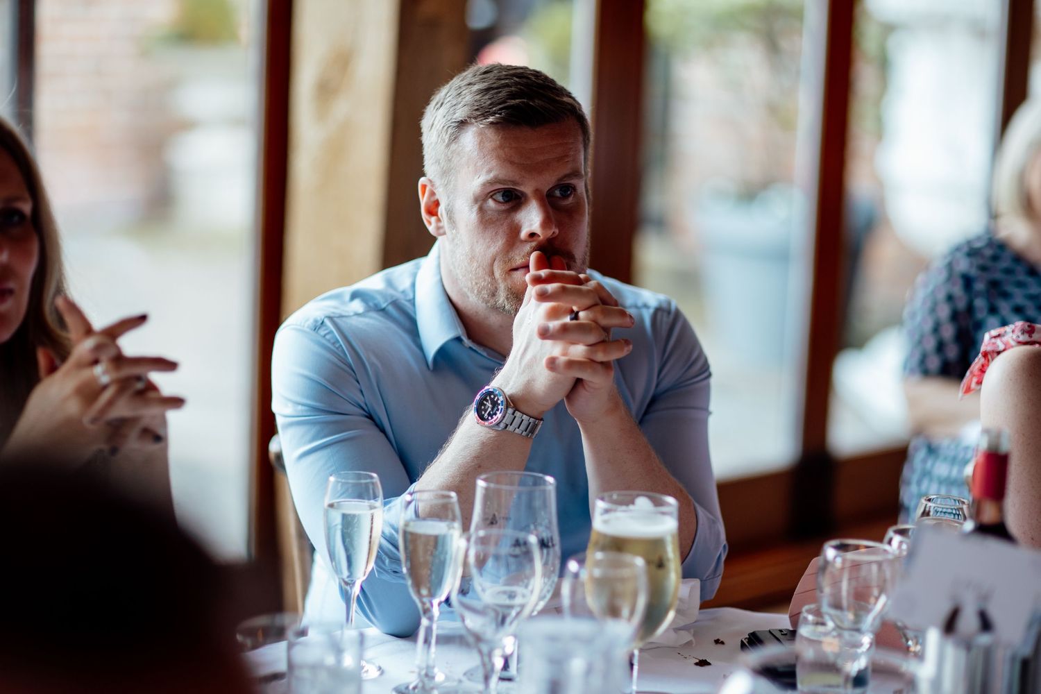 Guest enjoying drinks at elegant table setting during reception.