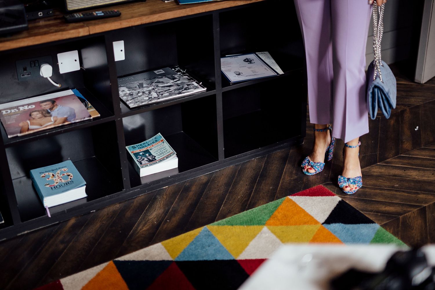 Interior room with wooden floors and colorful geometric pattern rug.