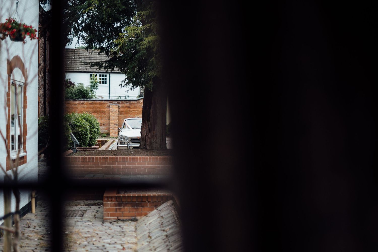 Exterior view of brick building through window frame.