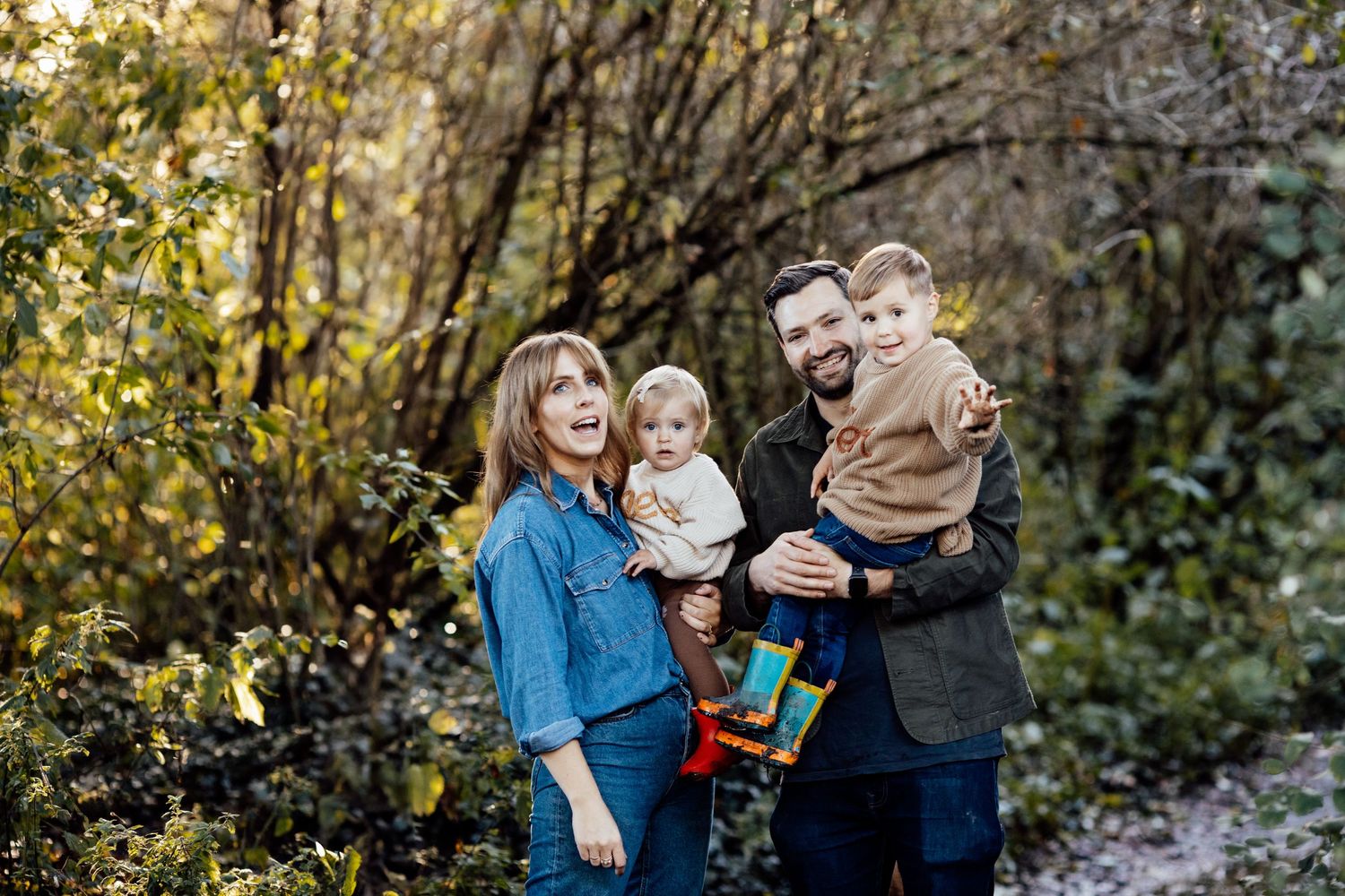 Family sharing intimate moments during outdoor autumn photo session.