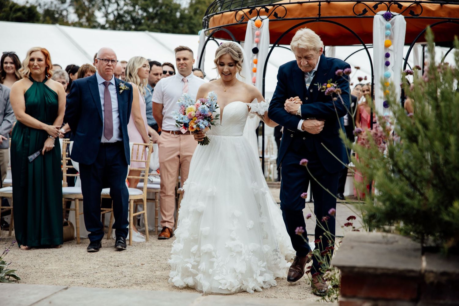 Wedding celebration with guests dancing and enjoying festivities at an outdoor venue.