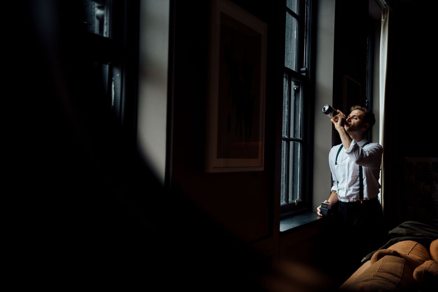 Moody interior shots with dramatic window lighting and shadows.