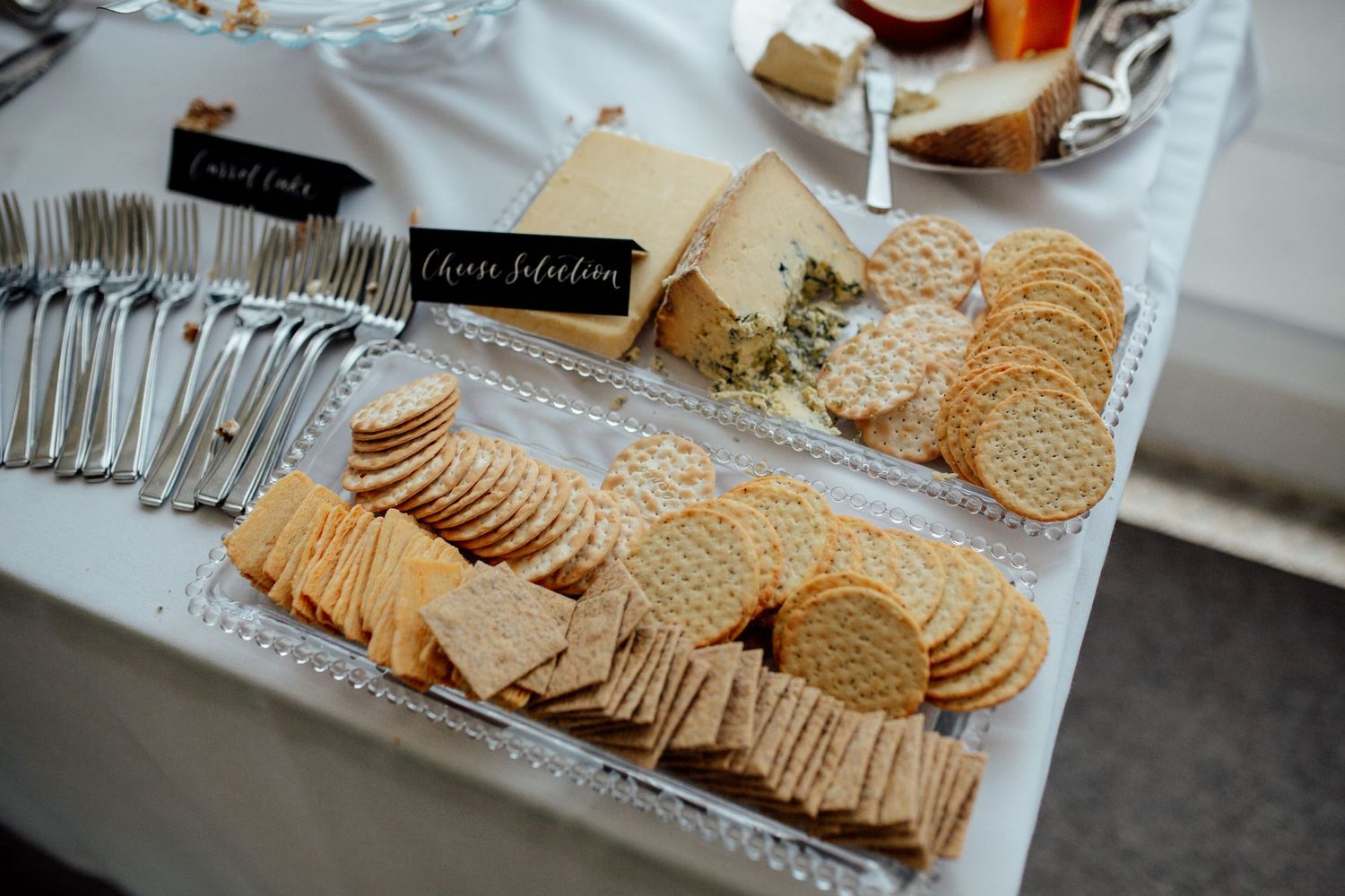 Appetizer display featuring crackers and cheese at wedding reception.