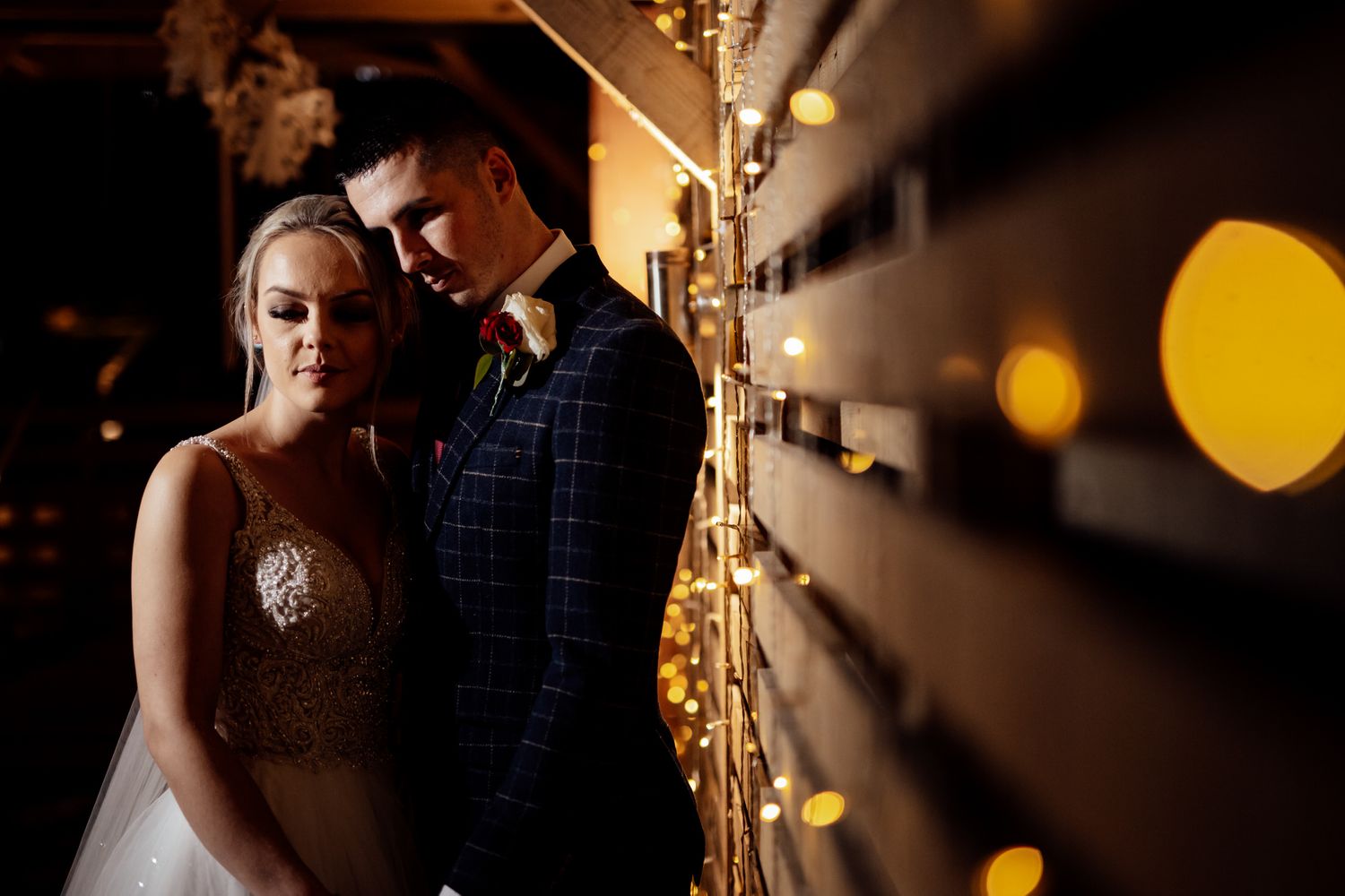 Romantic wedding dance captured with soft bokeh lights in background.