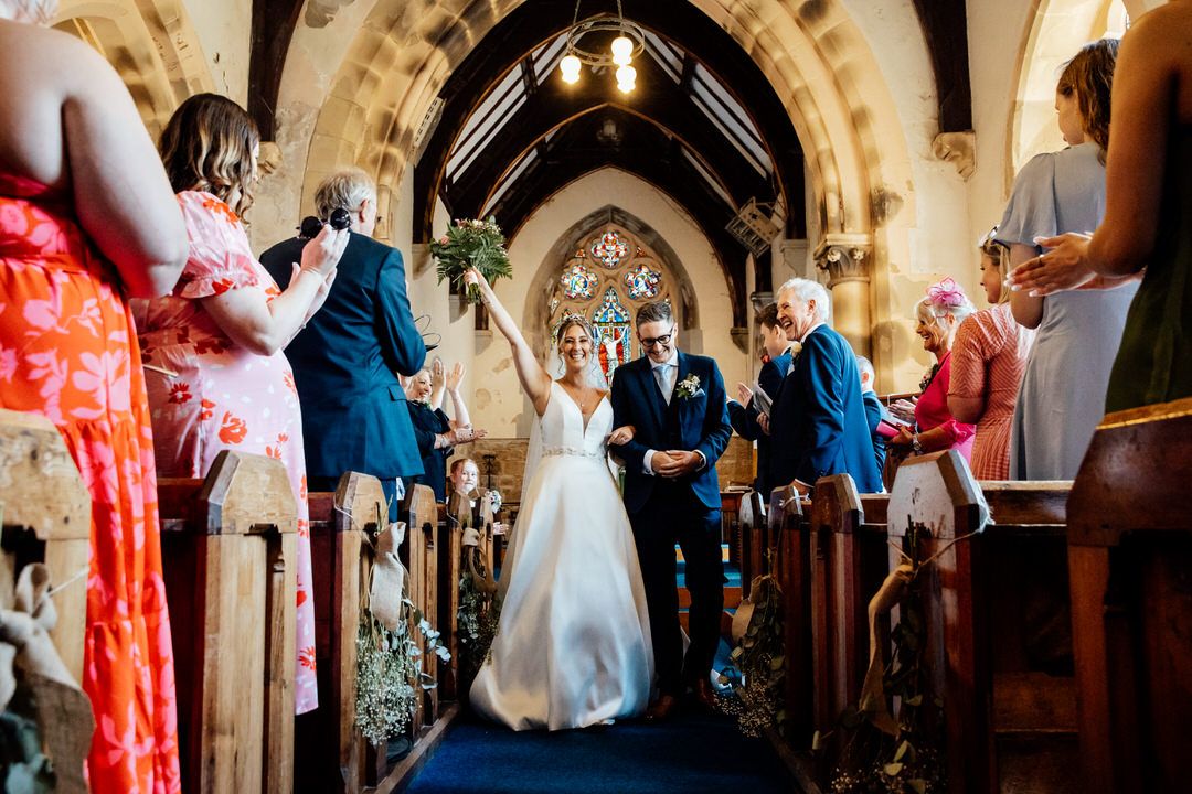 Gothic church arches and architecture frame intimate wedding ceremony.