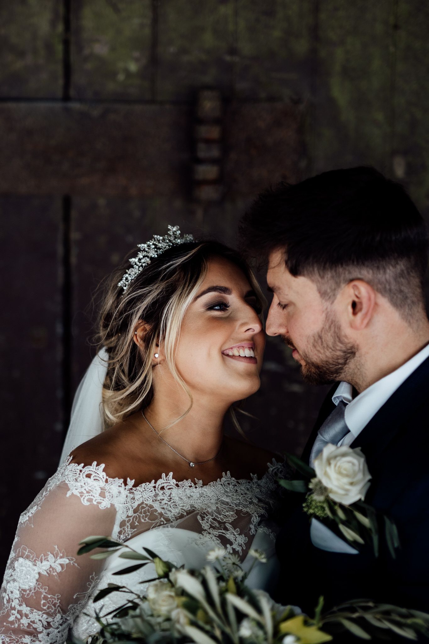 Intimate wedding portrait of couple sharing romantic moment.
