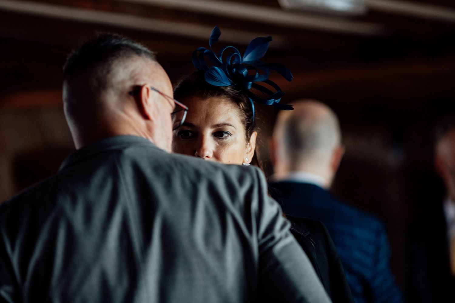 Wedding party in formal attire sharing emotional moments during a celebration.