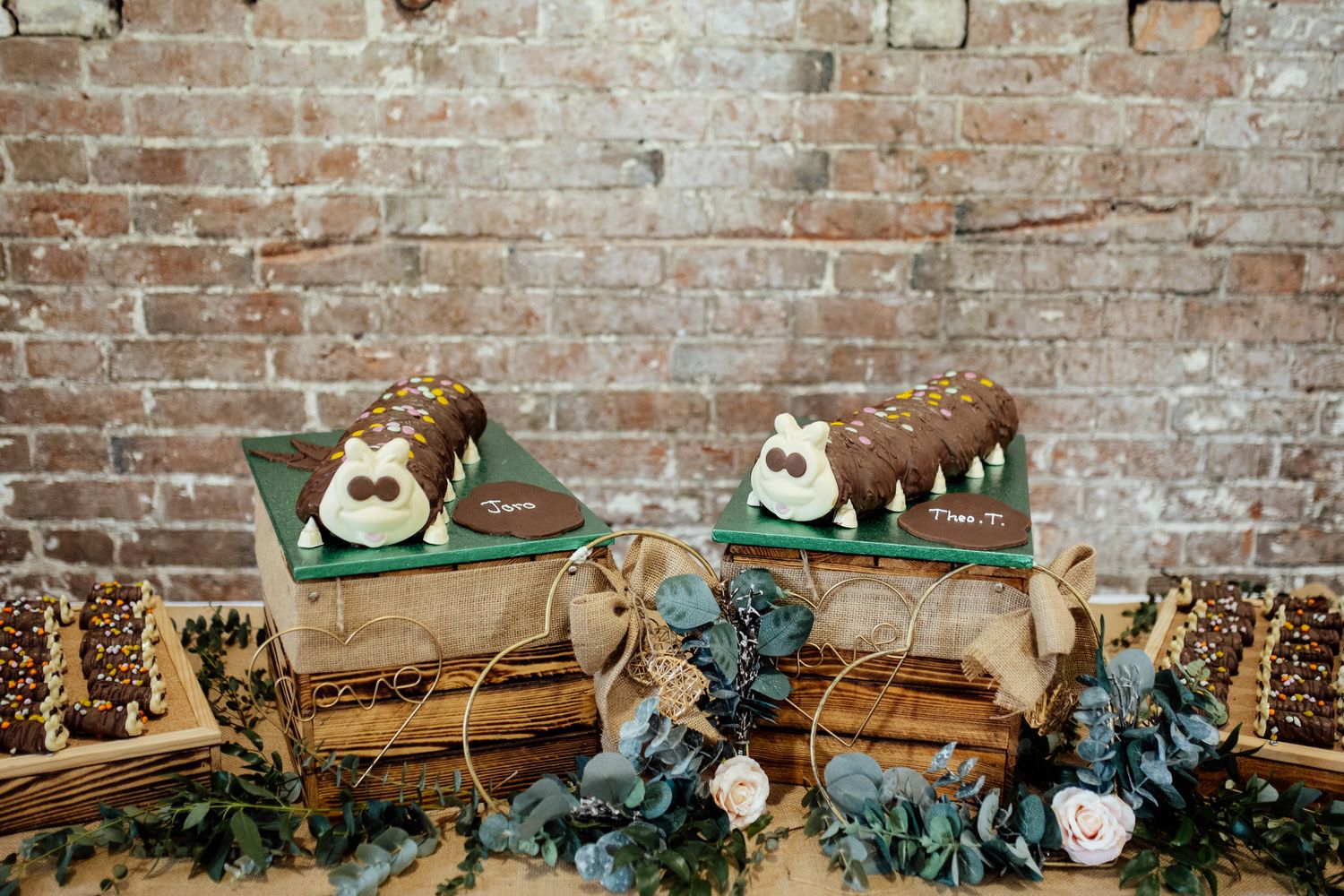 Rustic brick wall decorated with fairy lights and vintage decor for wedding reception.
