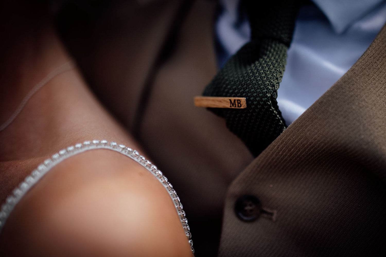 Close-up detail shot of wedding dress beading and fabric texture.