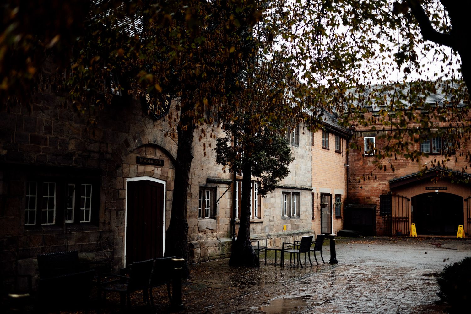 Historic stone building exterior with dramatic evening lighting.