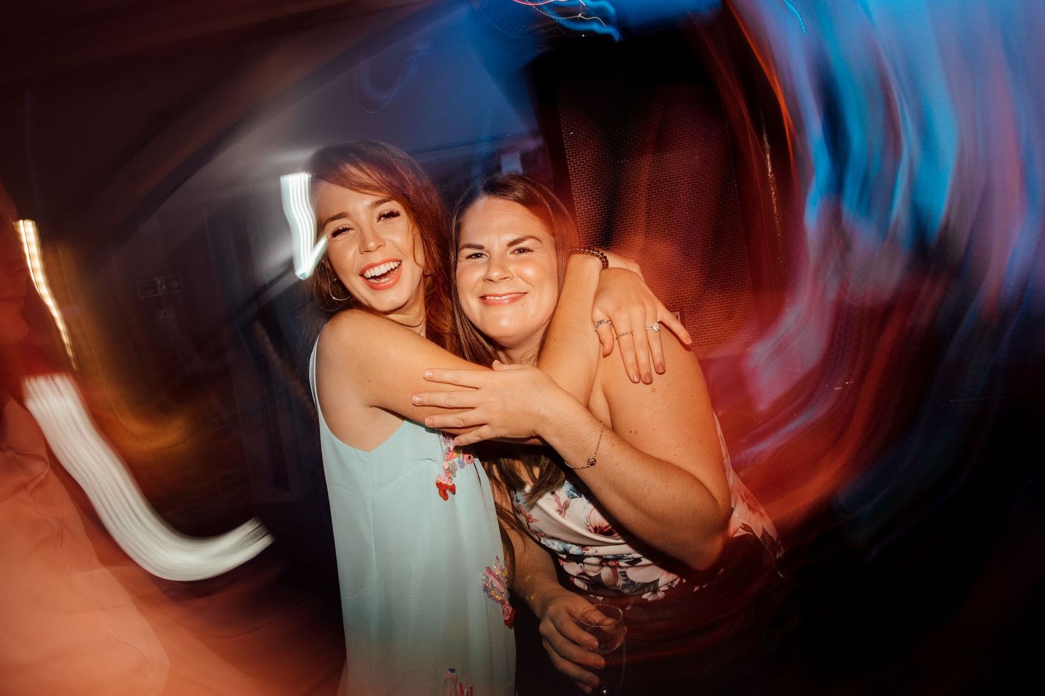 Friends celebrating with dynamic camera movement creating artistic blur effects.