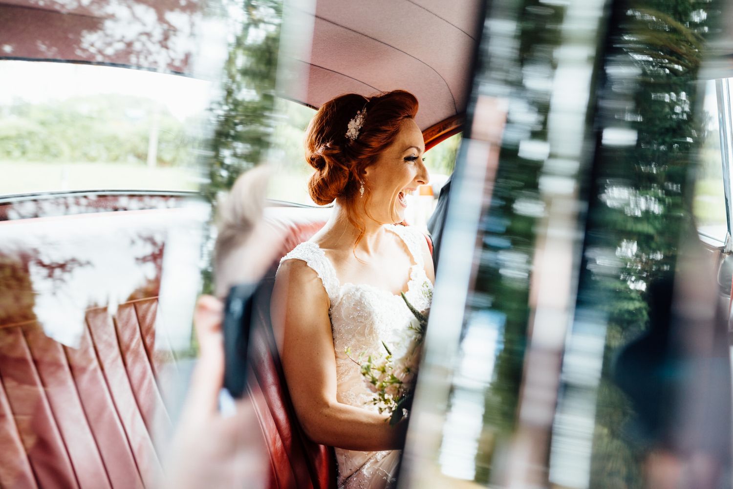 Artistic blurred wedding photography through glass with soft white reflections.