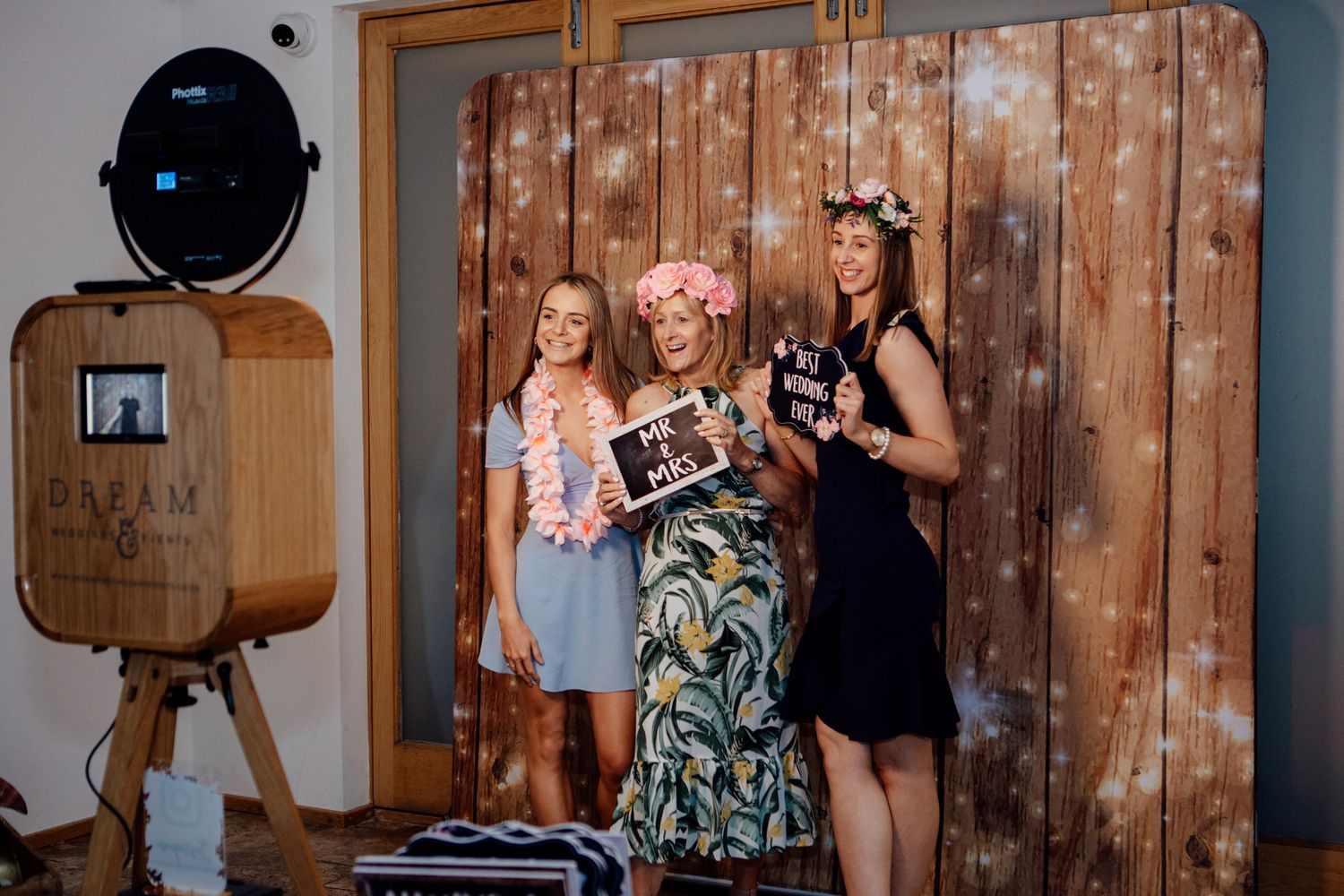 Wedding photography setup with rustic wood paneling and lighting equipment in a studio setting.