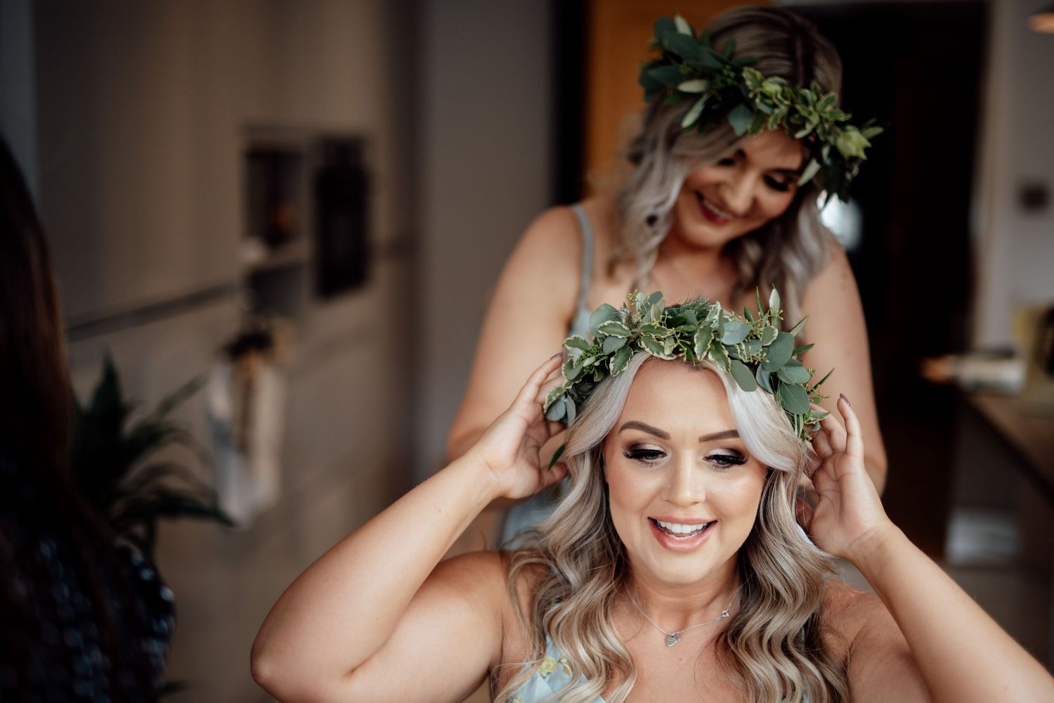 Bridal preparations with floral crown and natural lighting.