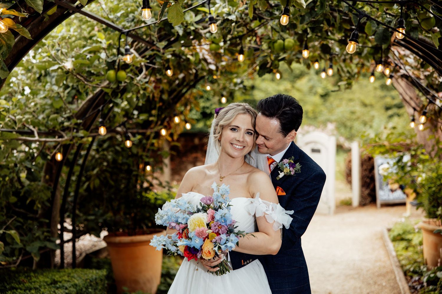 Romantic garden wedding ceremony with natural greenery and floral decorations.