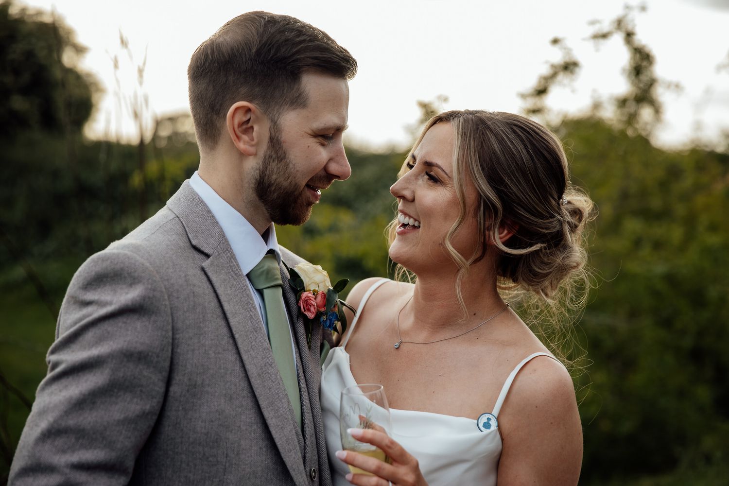 Candid moments between wedding couple during outdoor photo session.