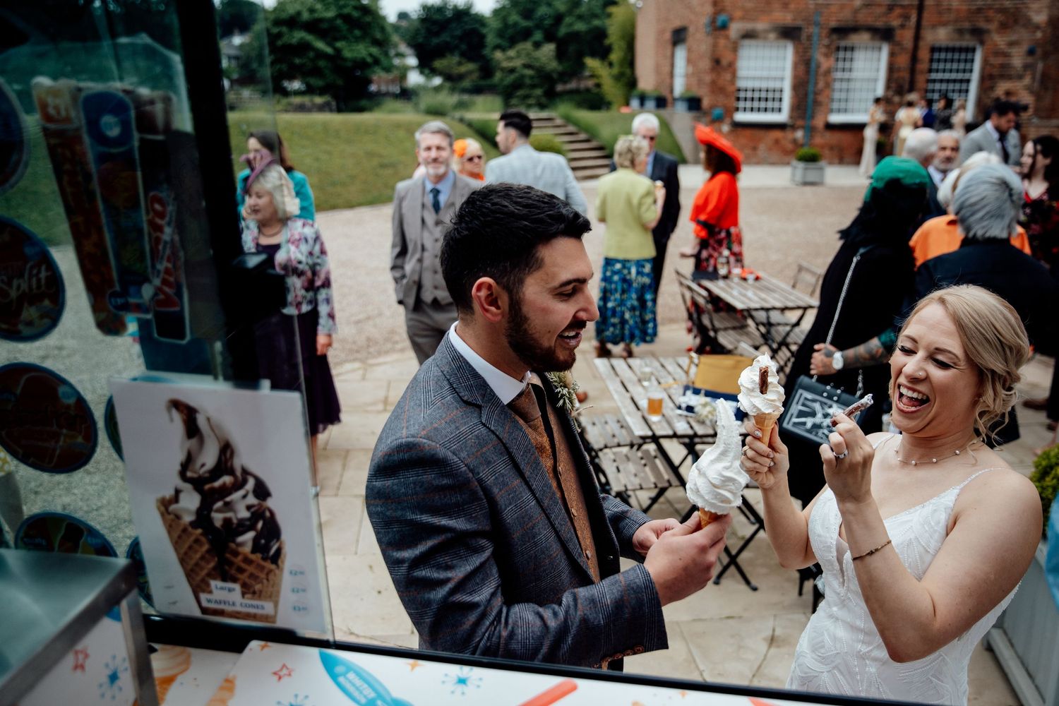 Wedding celebration candid moments captured outside a brick building.