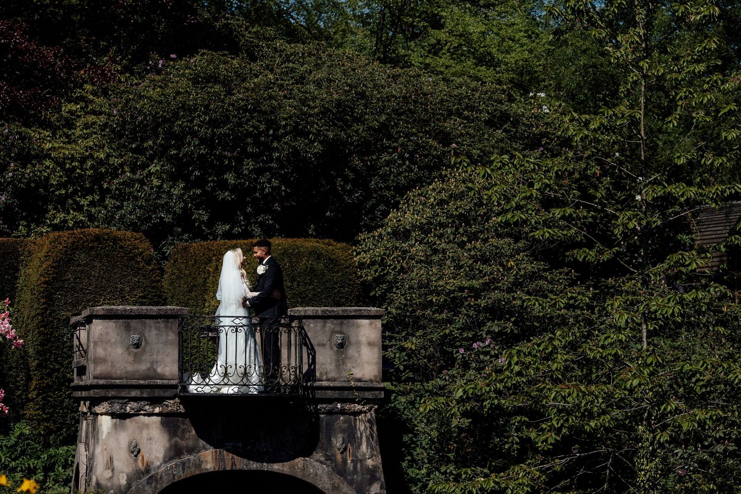 Wedding venue surrounded by lush green trees and landscaping.
