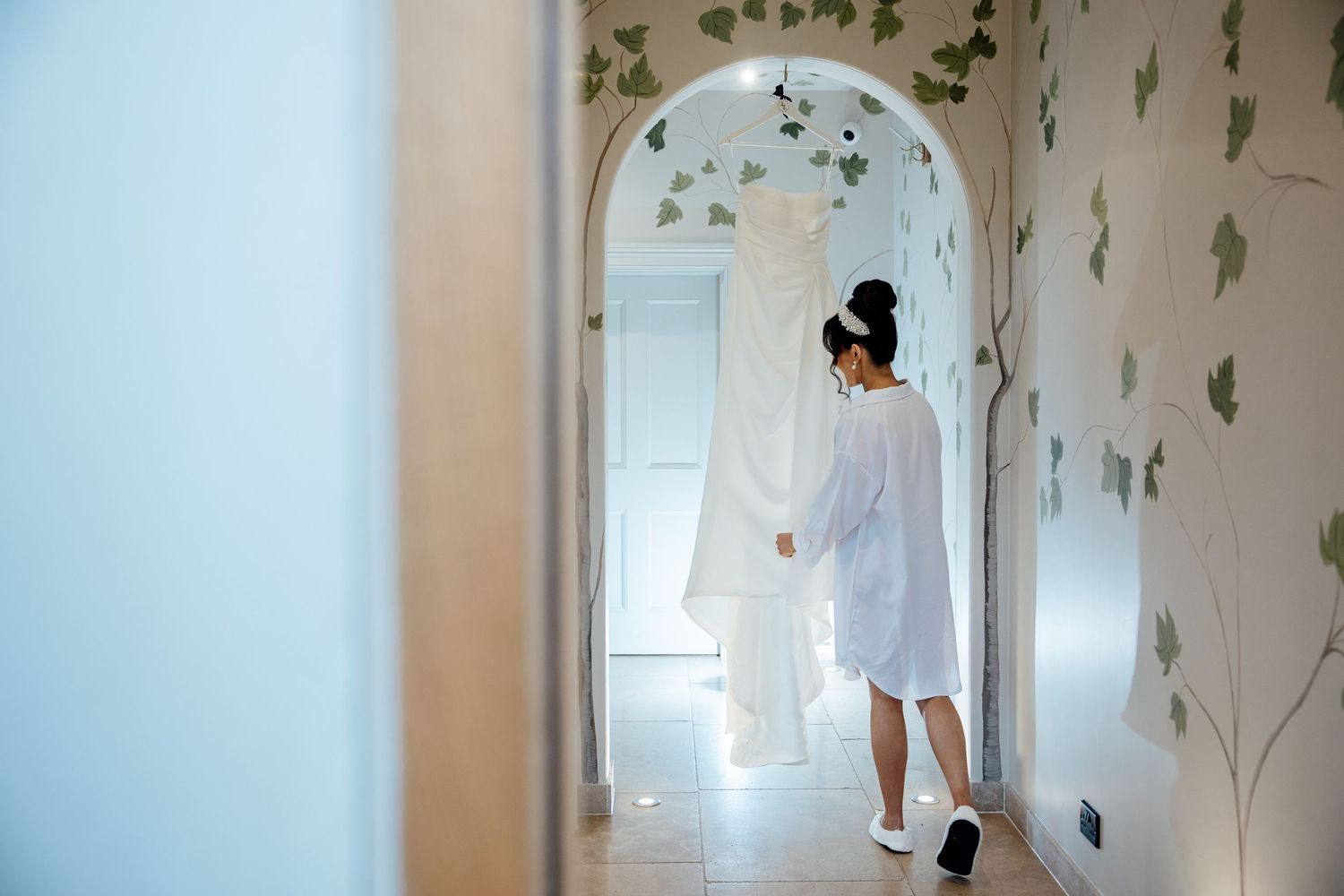 A series of photos showing a delicate floral wallpaper installation process in a bright interior hallway space.