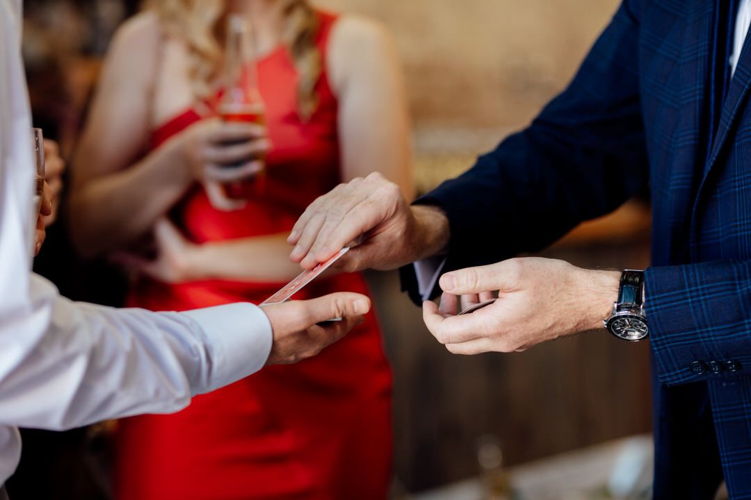 Close-up of hands exchanging rings during wedding ceremony.