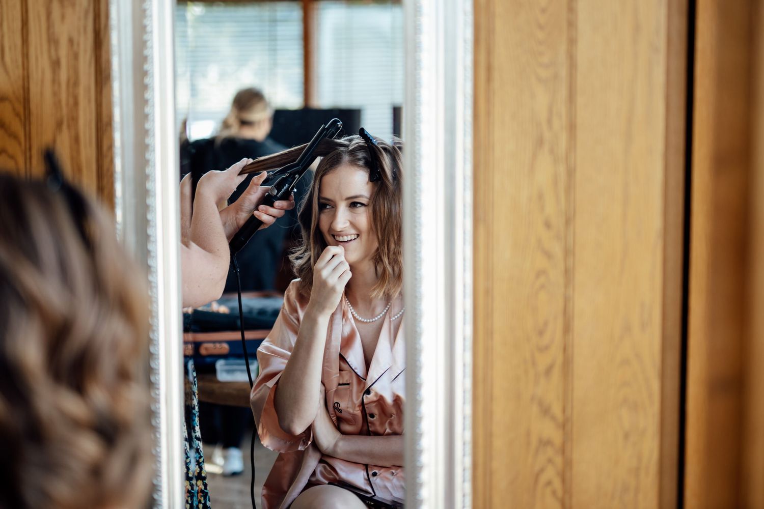 Getting ready scenes photographed through wooden window frames creating natural framing.