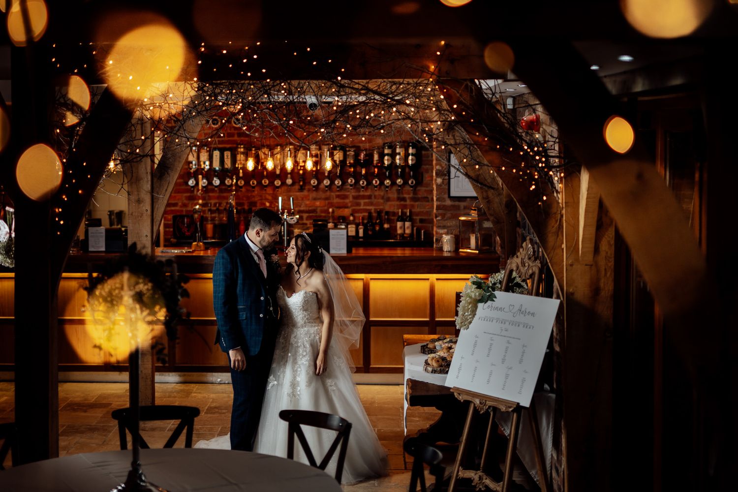 Wedding reception venue with warm lighting and decorative bokeh effects.