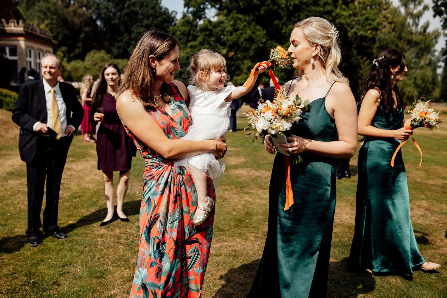 Wedding party celebrating and embracing outdoors in coordinated attire.
