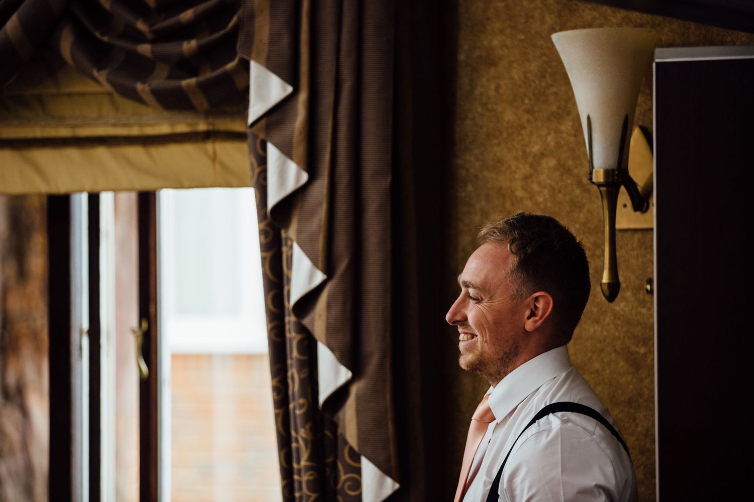 Candid moments captured during wedding preparations in a rustic indoor setting.