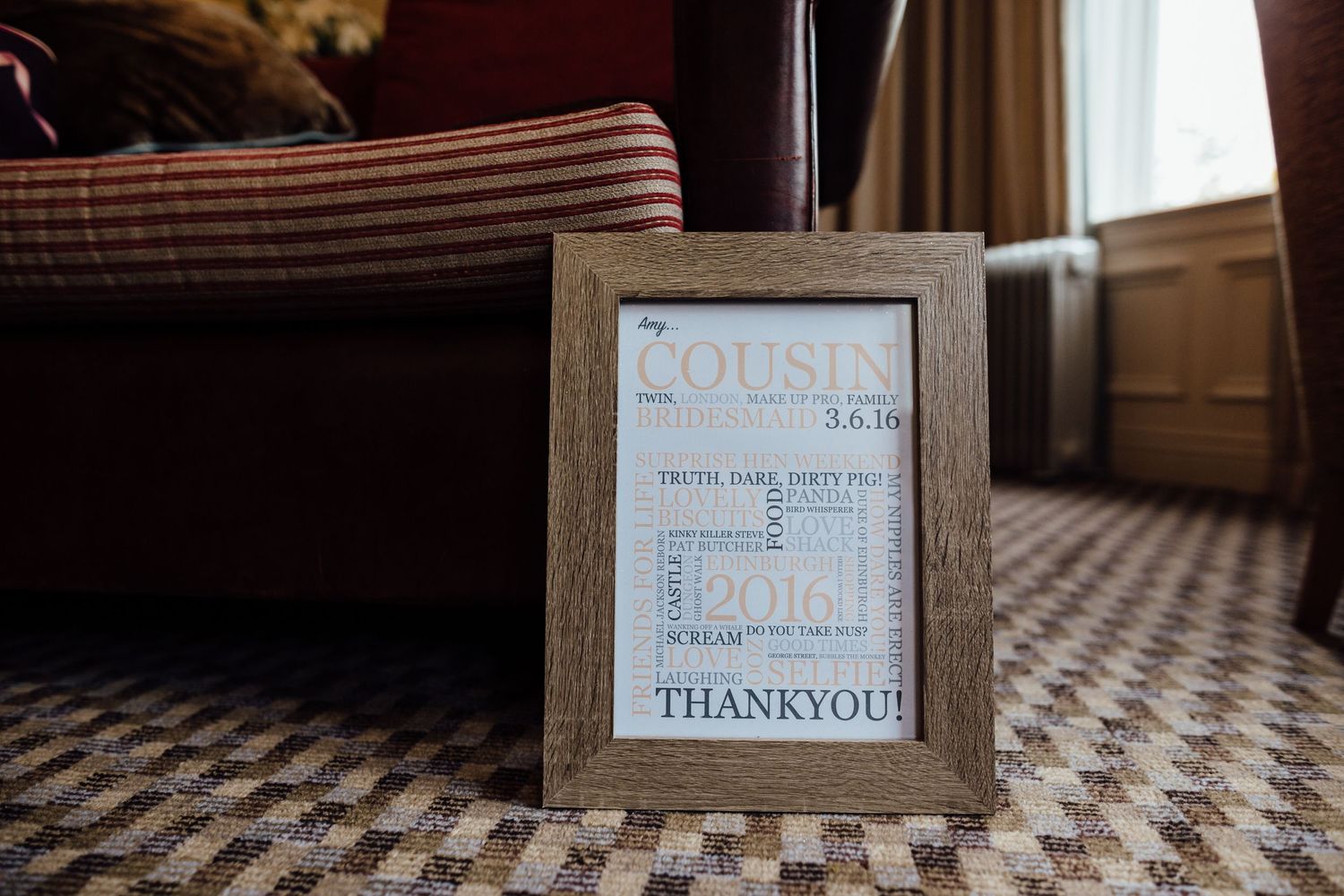 Wooden framed thank you sign on patterned carpet flooring.