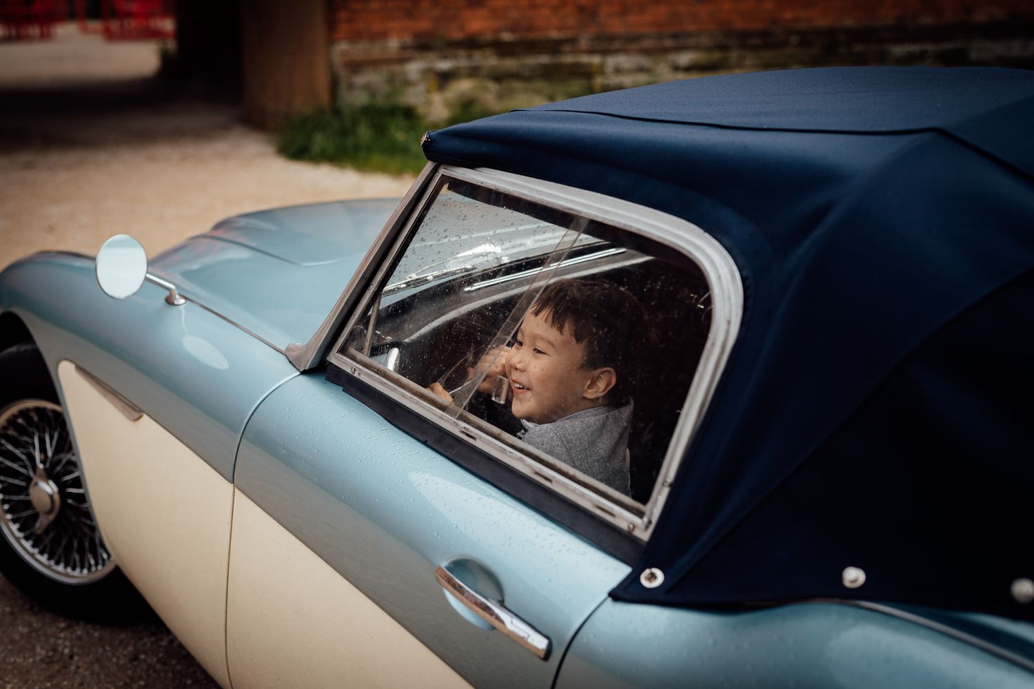 Classic vintage car in two-tone colors photographed during a wedding event.