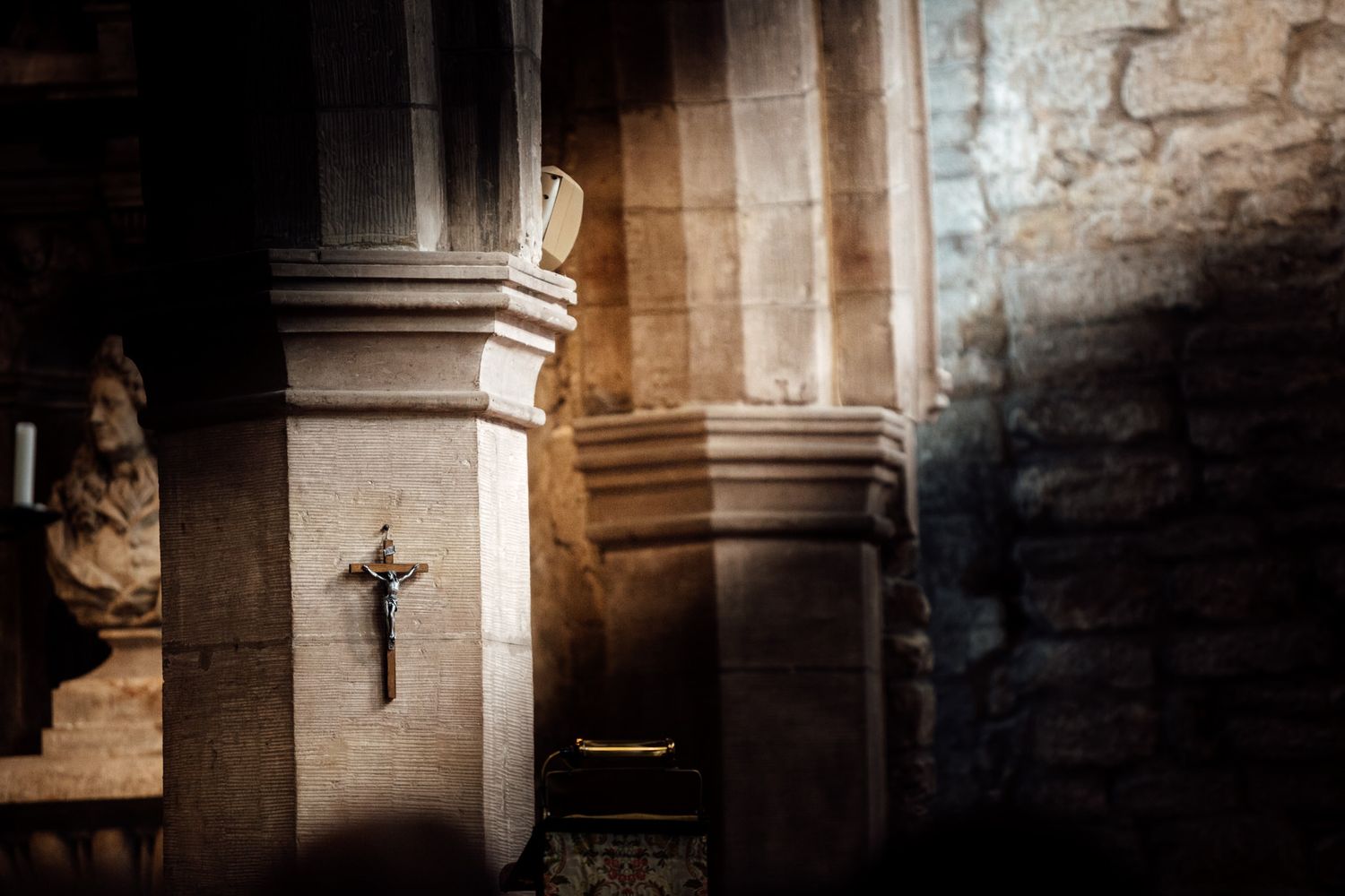 Atmospheric interior of stone church with dramatic lighting and architectural details.