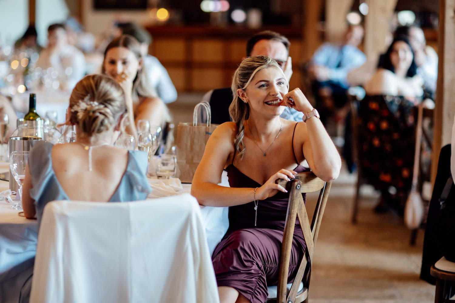 Wedding guests laugh and enjoy themselves during the reception dinner.