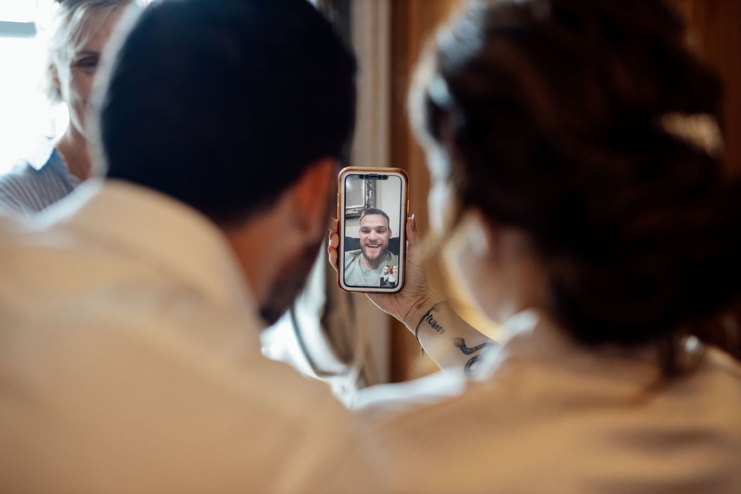 Wedding guests view and share moments on mobile phones during the celebration.