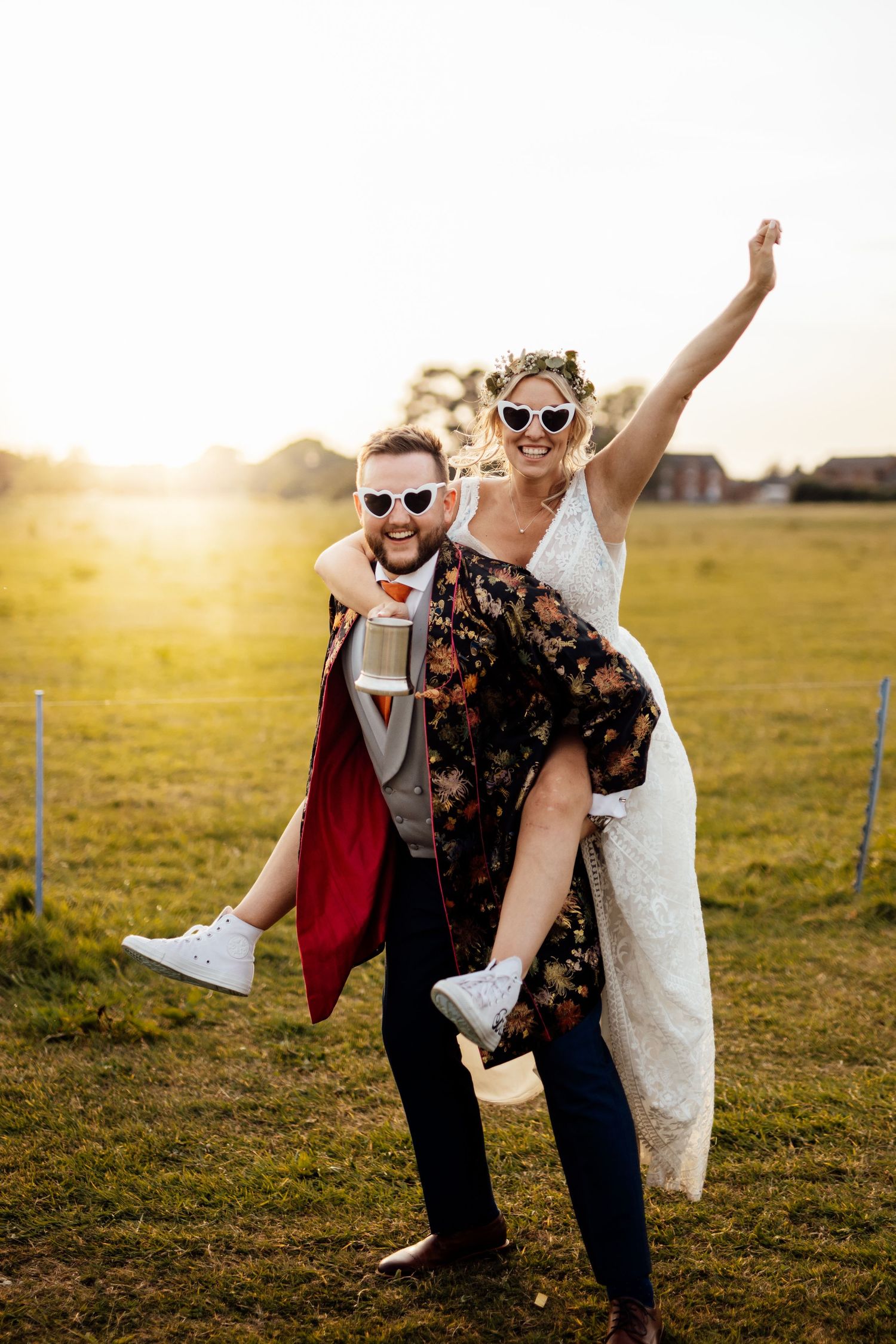 Joyful moment captured in golden sunlight on grassy field during celebration.