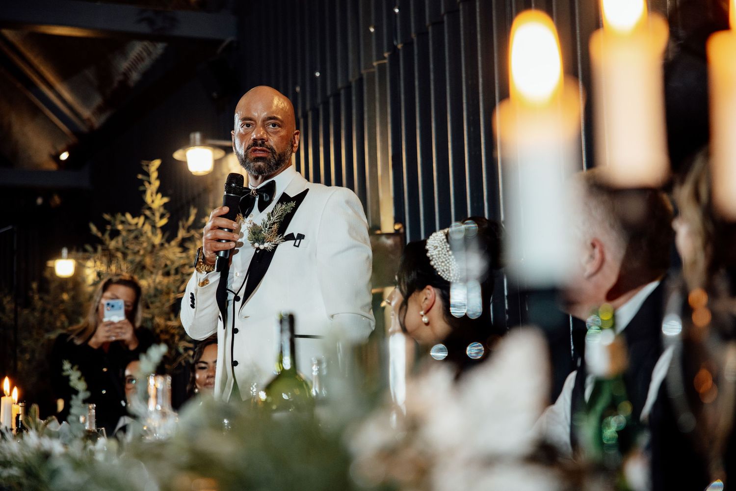 Wedding reception dinner setup with glowing lights and table decorations in an elegant venue.