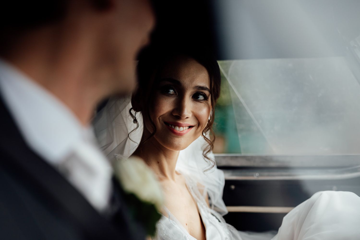 Elegant wedding couple in car sharing romantic moment.