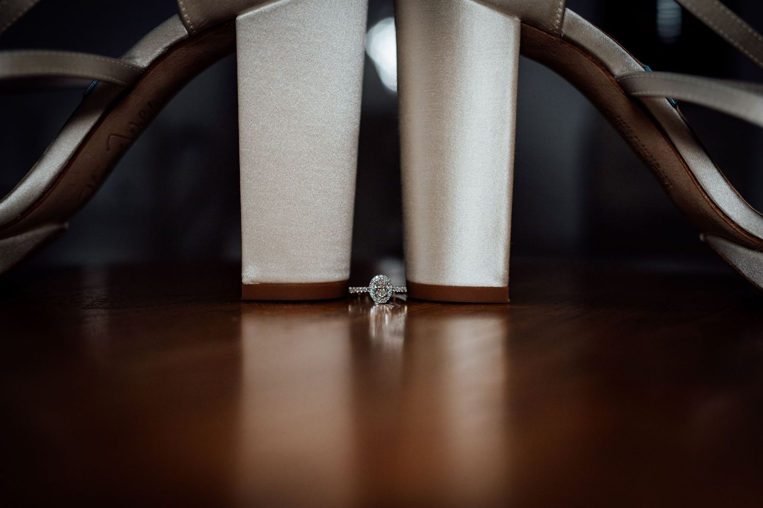 Close-up details of white wedding dress fabric and accessories.