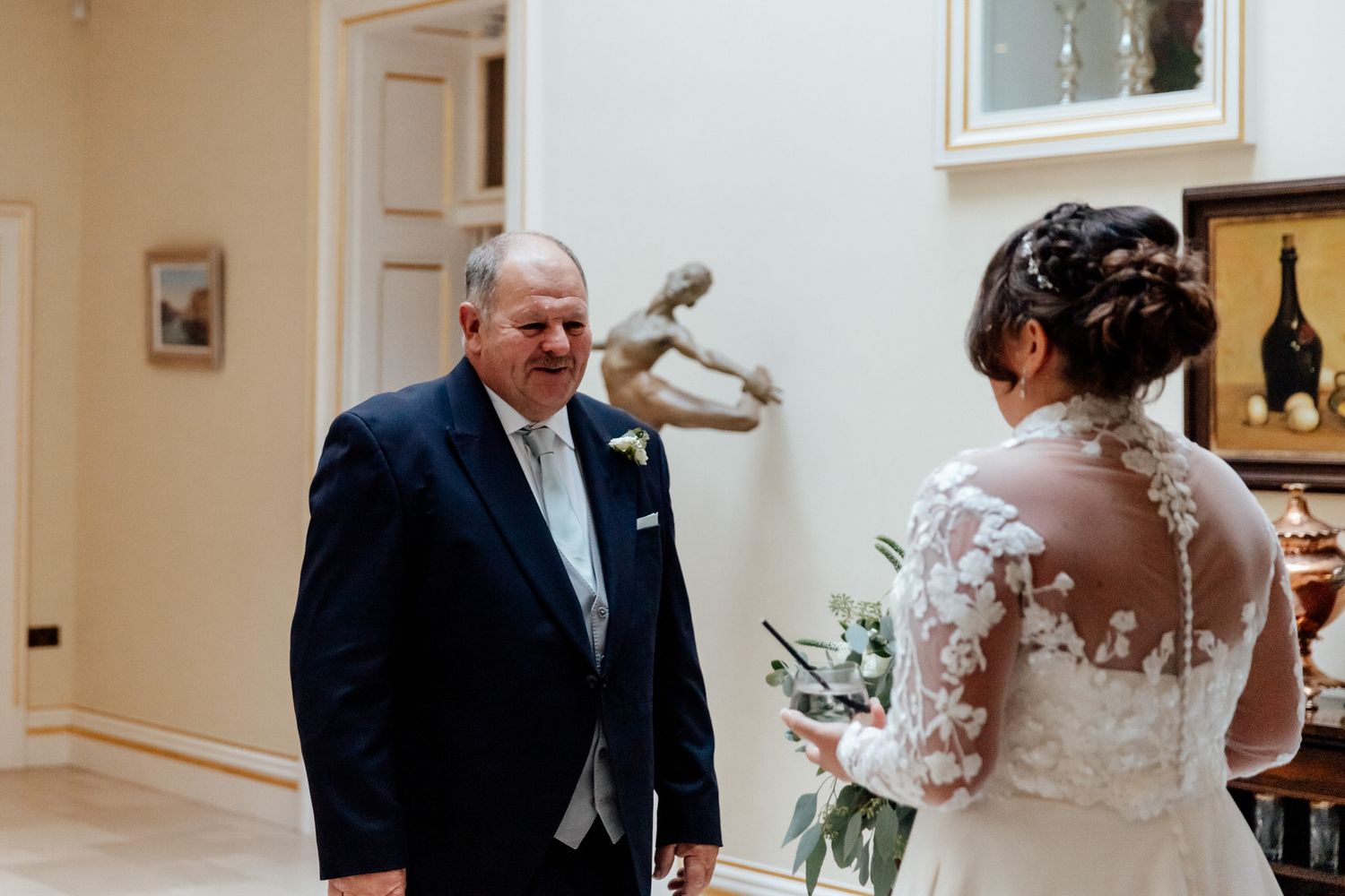 Wedding celebration candid moments captured inside an elegant white room.