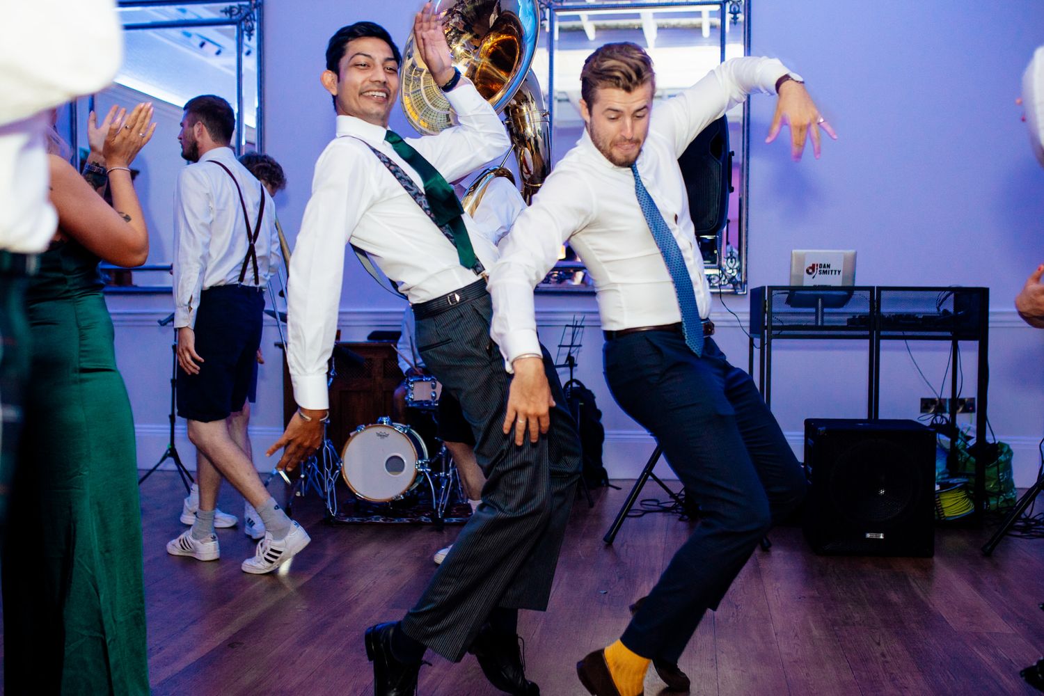 Wedding guests dancing in sync during a choreographed group dance number.