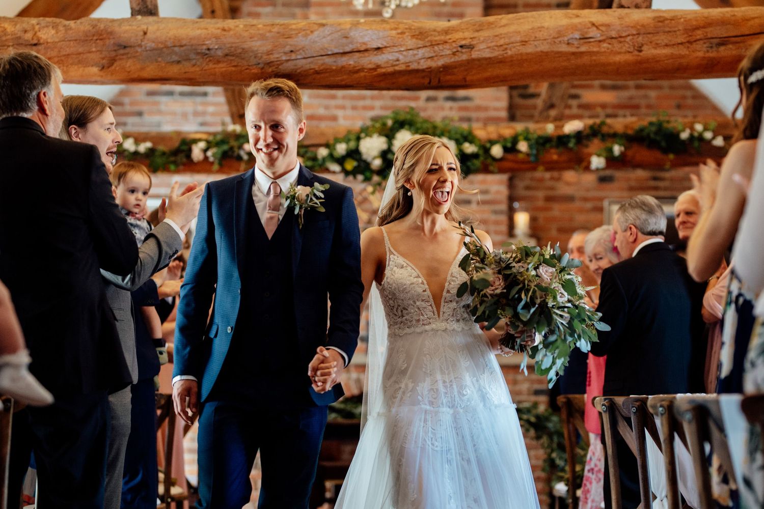 Wedding ceremony and reception moments captured in rustic indoor venue with exposed brick walls.