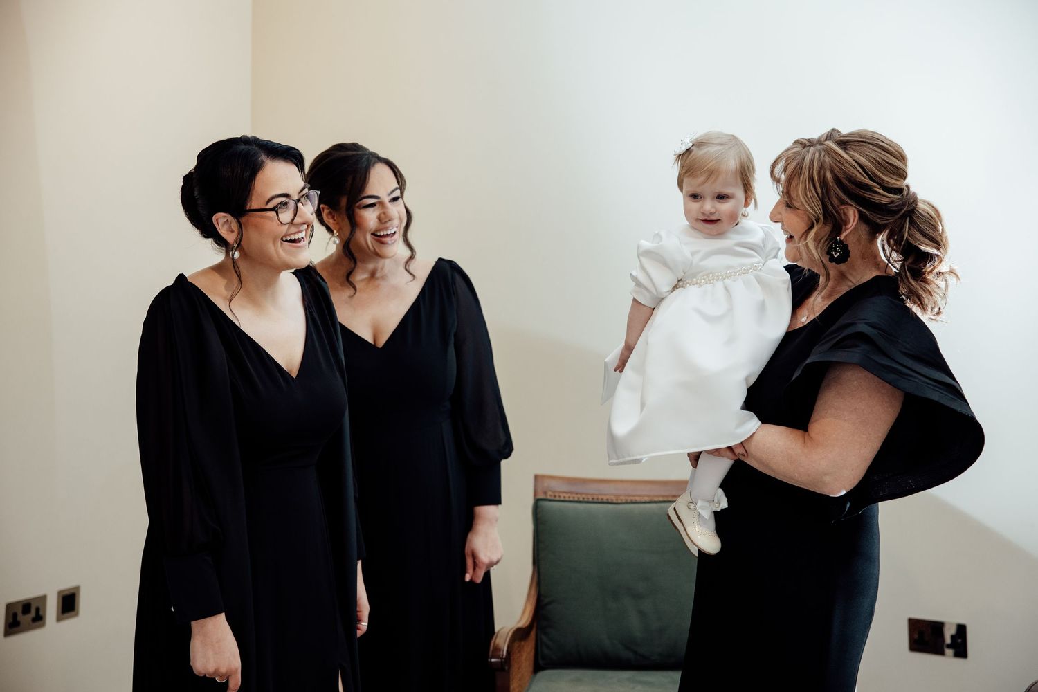 Wedding party members in black attire gathered together before the ceremony.