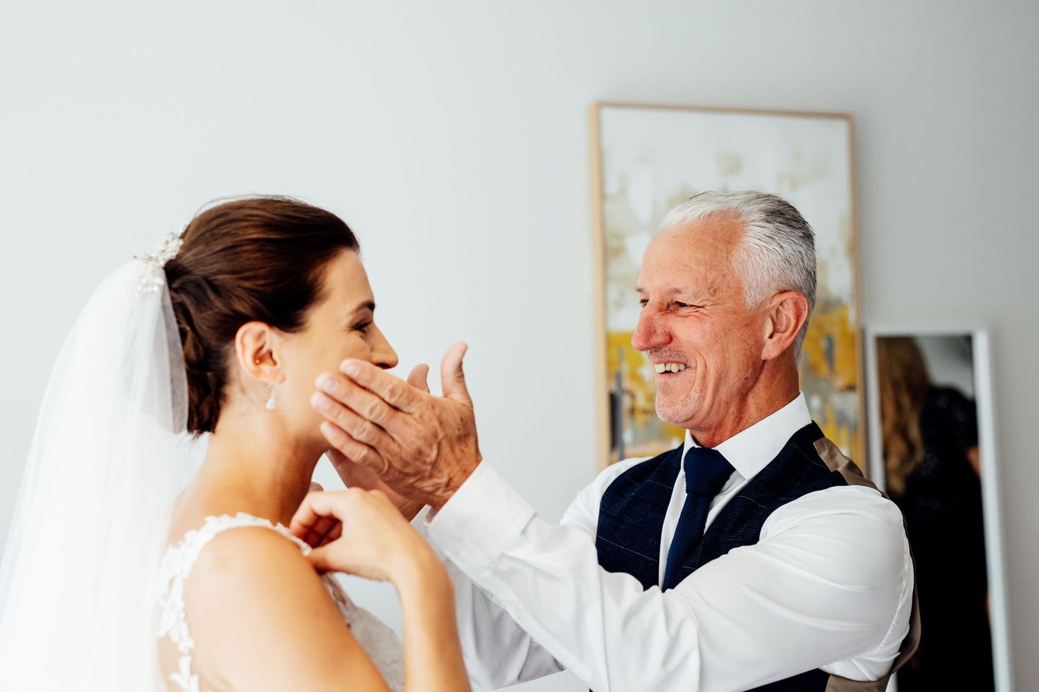 Emotional wedding day moments captured in an intimate indoor setting.