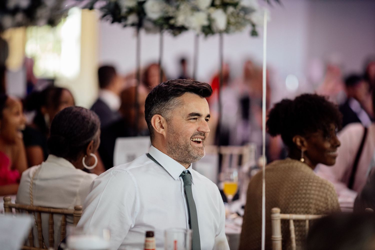 Wedding reception guests dancing and celebrating on a crowded dance floor.
